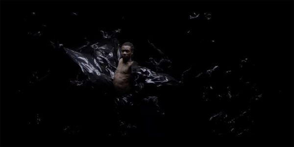 Jonsi Exhale Video Still Black dancer in Plastic