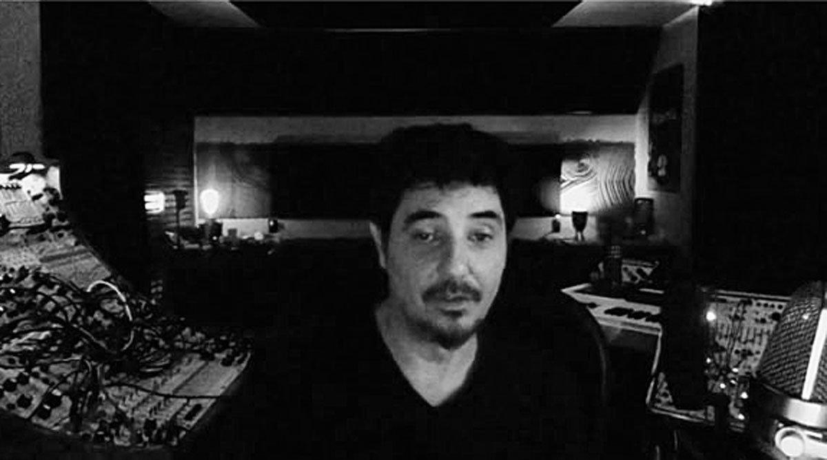 Amon Tobin in his studio surrounded by synthesizers. Black and White.